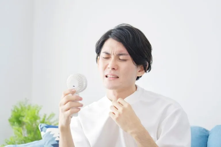 asian-man-using-portable-fan-home-1