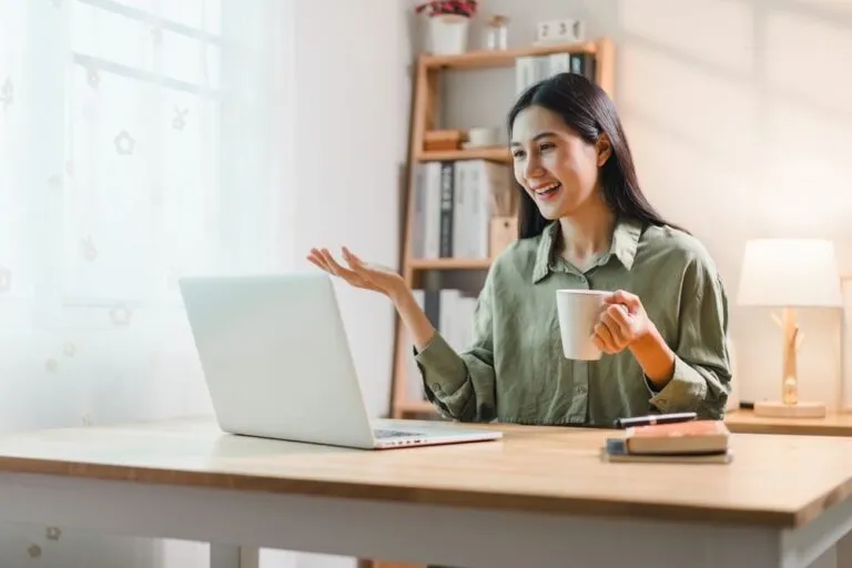 young-asian-woman-using-laptop-while-1