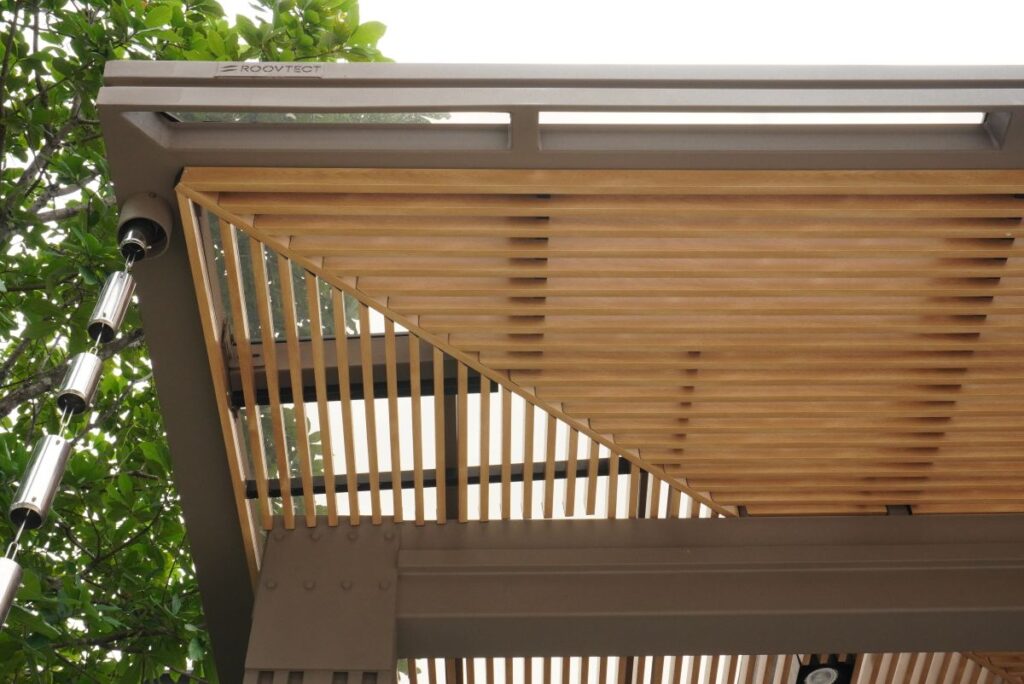 การต่อเติมหลังคาโรงรถไม่ให้บ้านมืดโดยการผสานวัสดุแบบโปร่งแสงและระแนงไม้ 